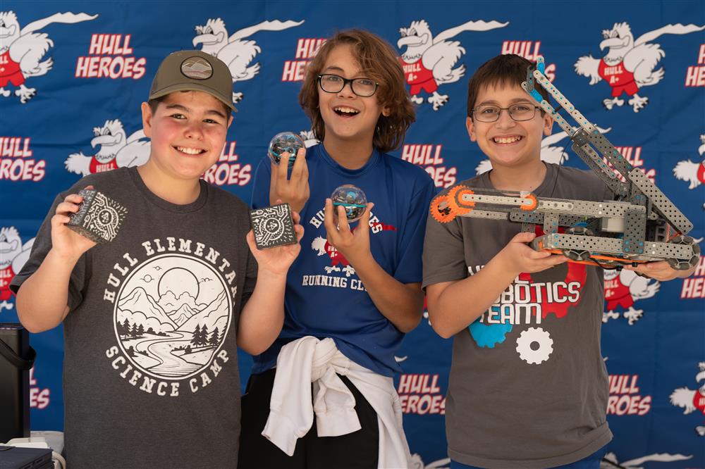 A group photo of Hull Elementary School students with robots they coded and built.